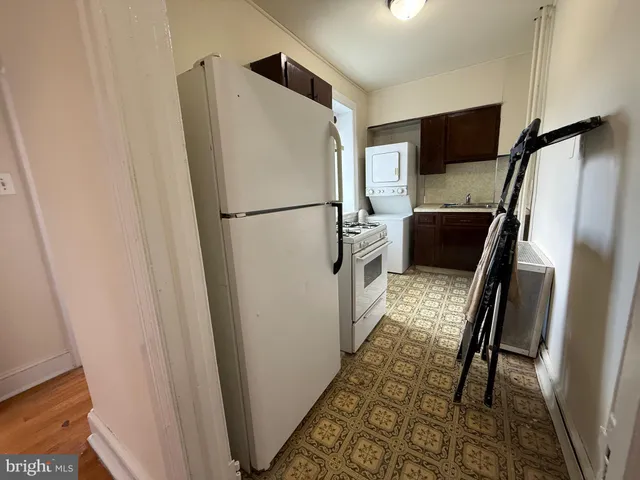 a white refrigerator freezer and a stove sitting inside of a kitchen