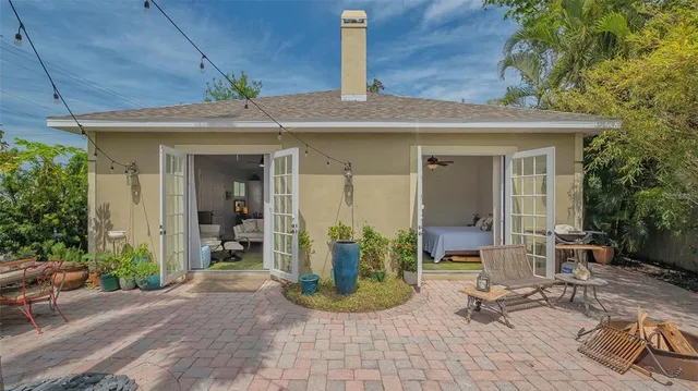 a backyard of a house with table and chairs