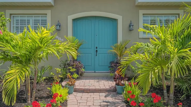 a front view of a house with a yard and trees
