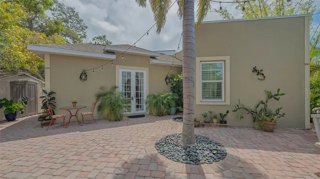 a kitchen with granite countertop a stove a sink and dishwasher with white cabinets