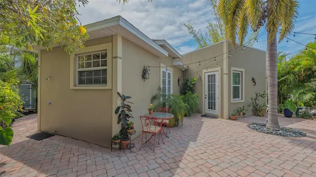 a kitchen with a table chairs and cabinets