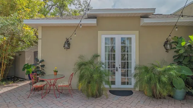 a backyard of a house with barbeque oven table and chairs