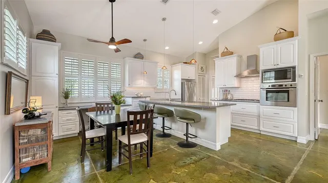 a kitchen with white cabinets and a stove top oven