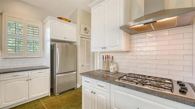 a bathroom with a granite countertop sink and a window