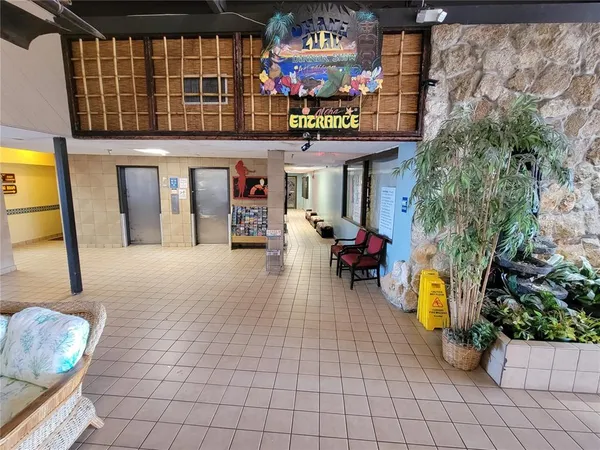 a view of a lobby with furniture and potted plants