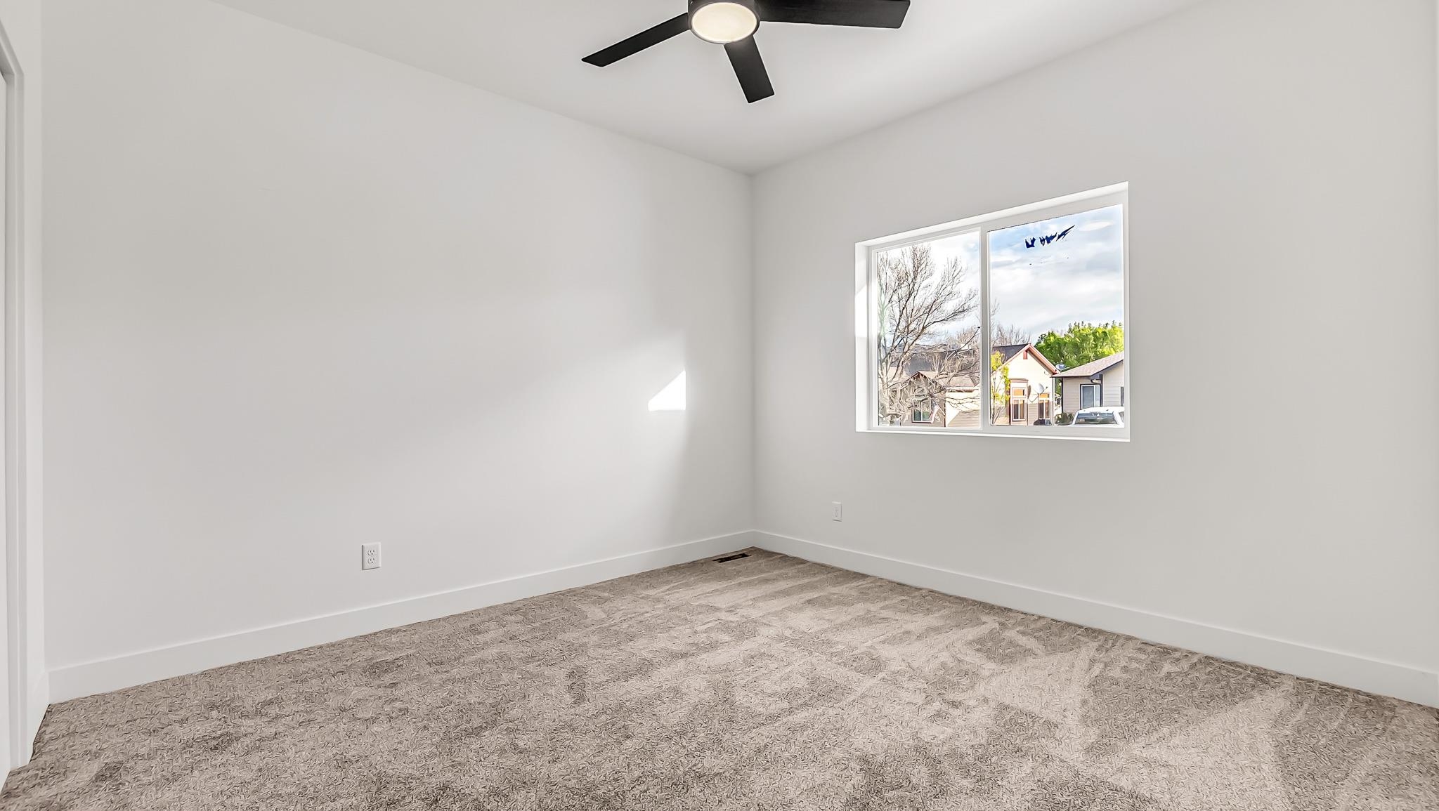 214 Limberpine Circle Parachute, CO 81635 - Photo 15 of 24 an empty room with a window and a ceiling fan