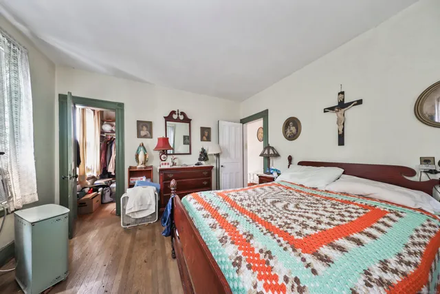 a bedroom with two beds and a large window