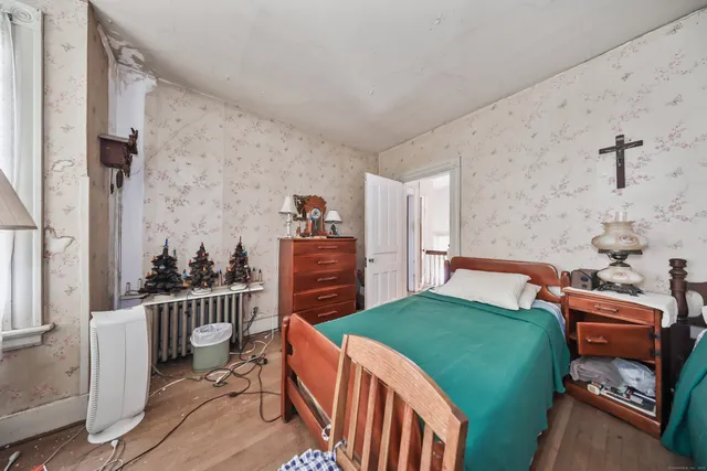 a bed room with a bed mirror and a window