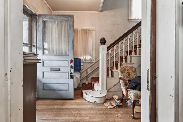 a view of entryway and hall with wooden floor