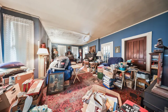 a living room with lots of furniture and wooden floor