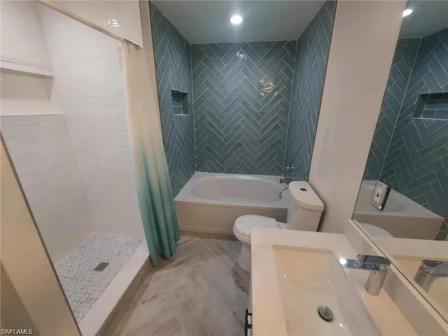 a bathroom with a tub and sink
