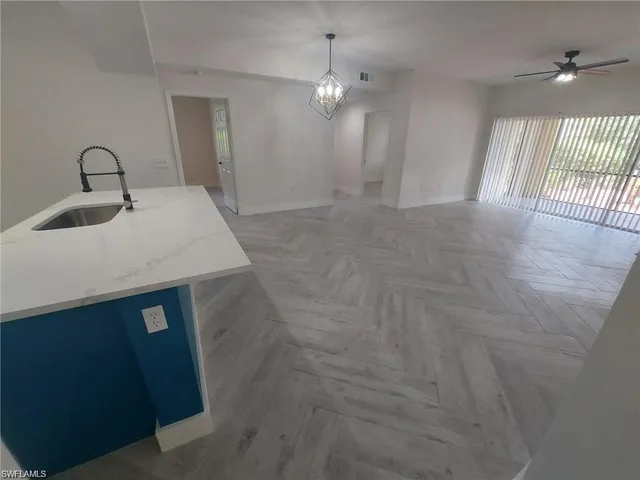 a bathroom with a sink a light fixture and a mirror