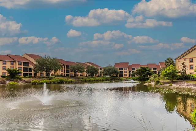 a view of residential houses with outdoor space and lake view