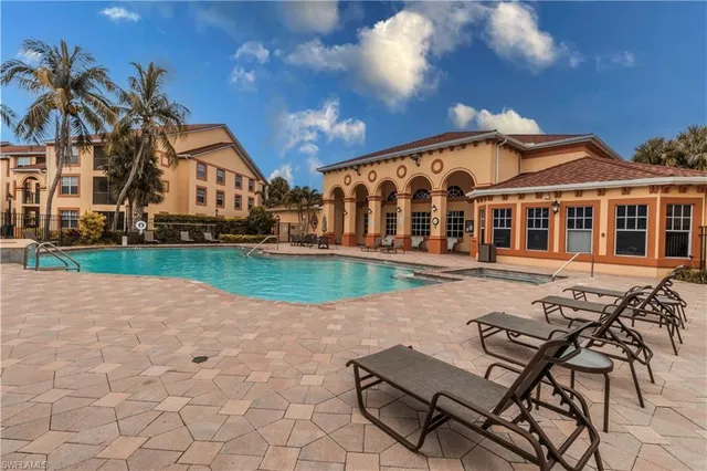 a view of a house with backyard and sitting area