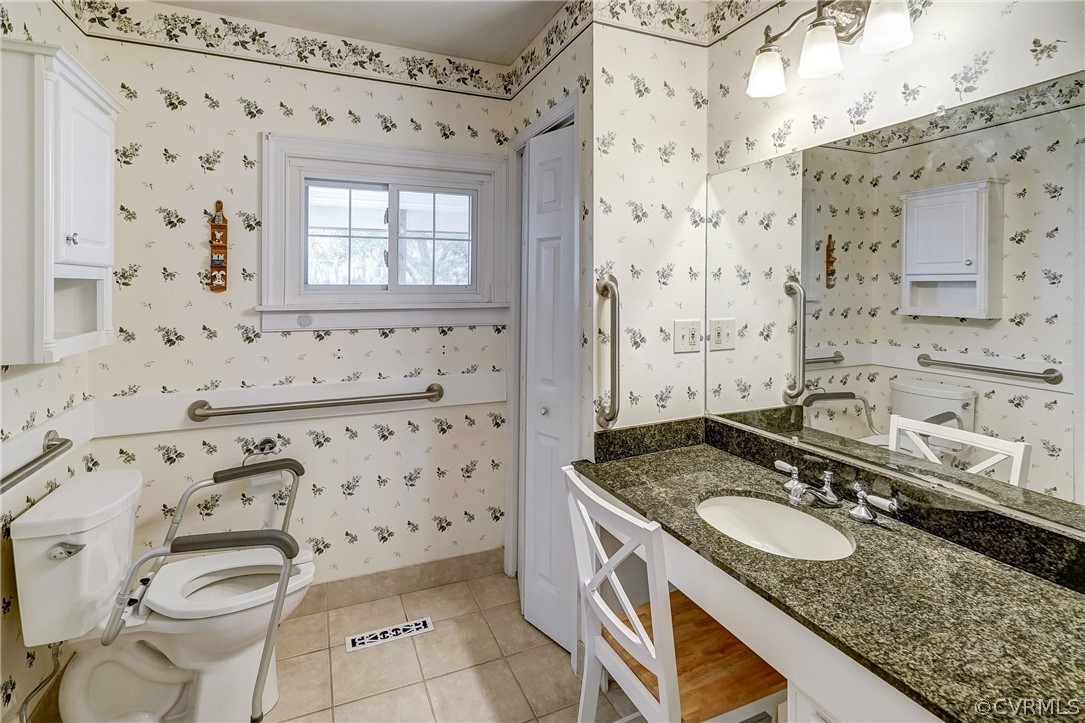 17110 Egglestetton Road Amelia Court House, VA 23002 - Photo 17 of 50 a bathroom with a granite countertop sink a toilet and a shower