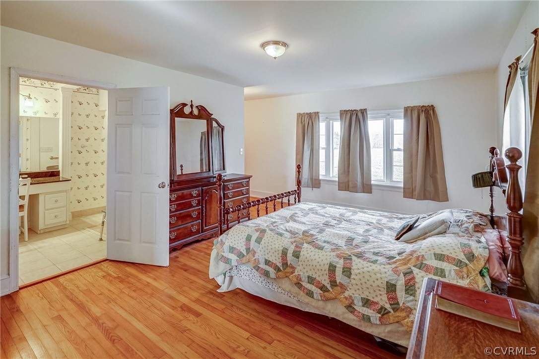 17110 Egglestetton Road Amelia Court House, VA 23002 - Photo 21 of 50 a bedroom with a bed and wooden floor