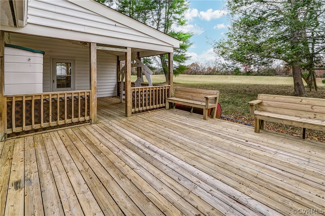17110 Egglestetton Road Amelia Court House, VA 23002 - Photo 28 of 50 a view of a wooden deck with a bench