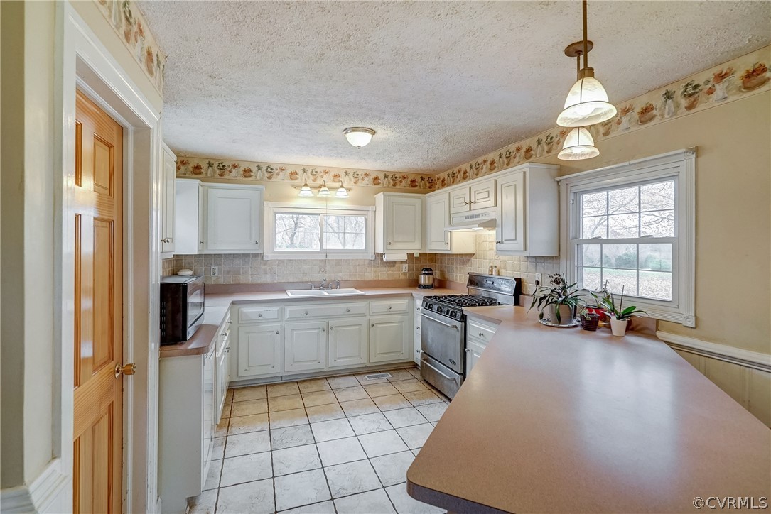 17110 Egglestetton Road Amelia Court House, VA 23002 - Photo 8 of 50 a kitchen with sink cabinets and window