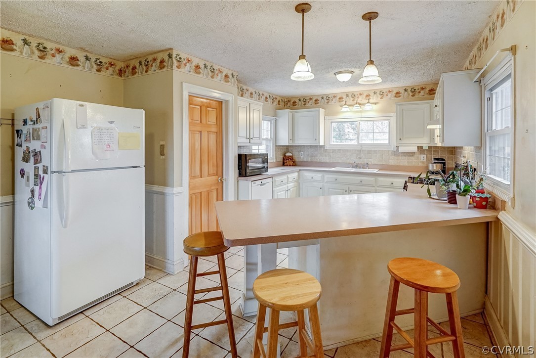 17110 Egglestetton Road Amelia Court House, VA 23002 - Photo 10 of 50 a kitchen with stainless steel appliances granite countertop a sink a refrigerator a stove a dining table and chairs with wooden floor