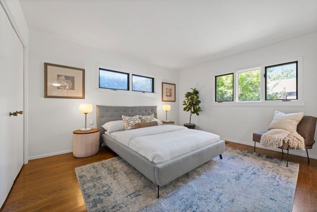 a bedroom with a bed and window