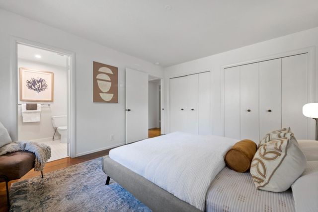 a bedroom with a bed and a couch