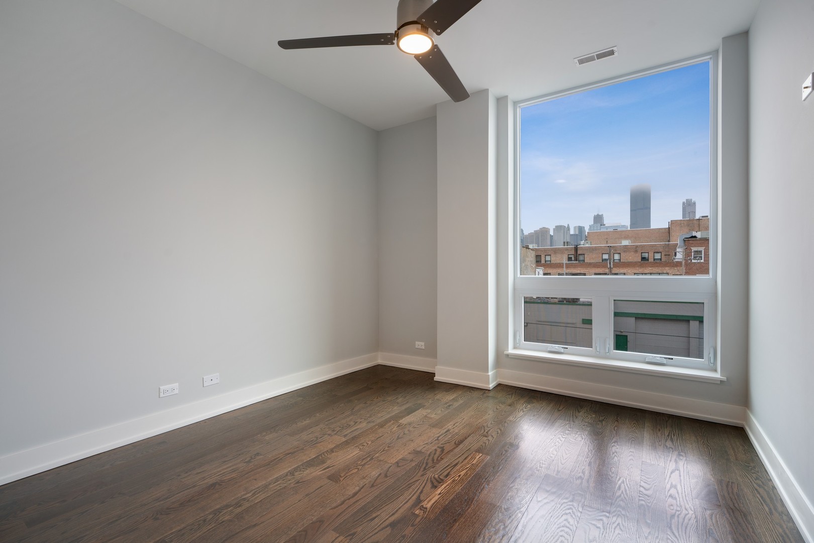 236 South Racine Avenue, Unit 304 Chicago, IL 60607 - Photo 16 of 23 an empty room with wooden floor cabinet and windows