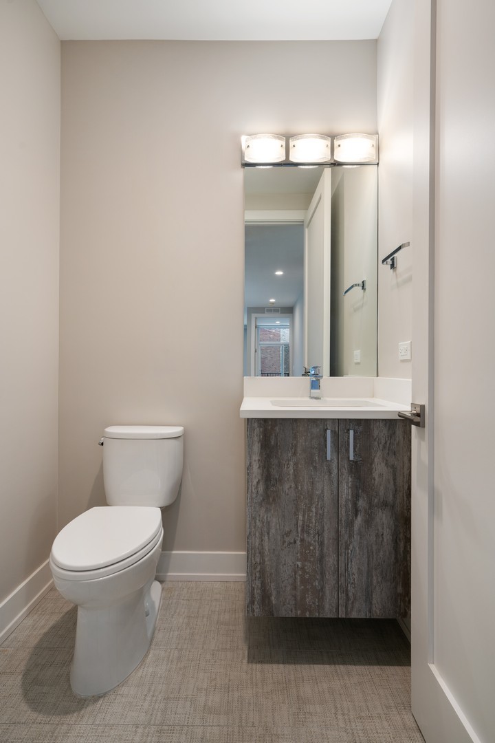 236 South Racine Avenue, Unit 304 Chicago, IL 60607 - Photo 17 of 23 a bathroom with a toilet a sink and mirror
