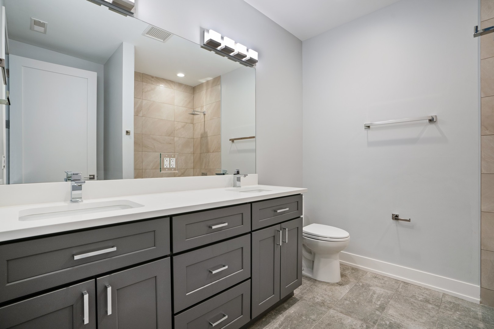 236 South Racine Avenue, Unit 304 Chicago, IL 60607 - Photo 18 of 23 a bathroom with a double vanity sink toilet and a mirror