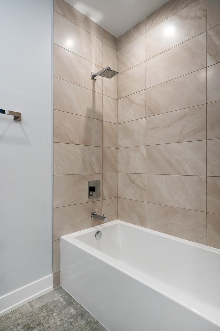236 South Racine Avenue, Unit 304 Chicago, IL 60607 - Photo 19 of 23 a bathroom with a bathtub and shower