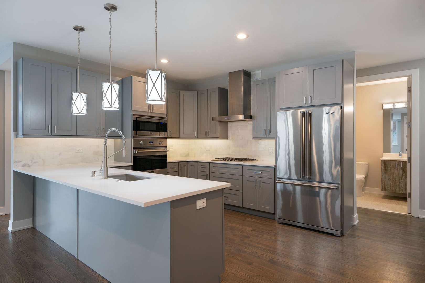 236 South Racine Avenue, Unit 304 Chicago, IL 60607 - Photo 5 of 23 a kitchen with refrigerator cabinets and wooden floor