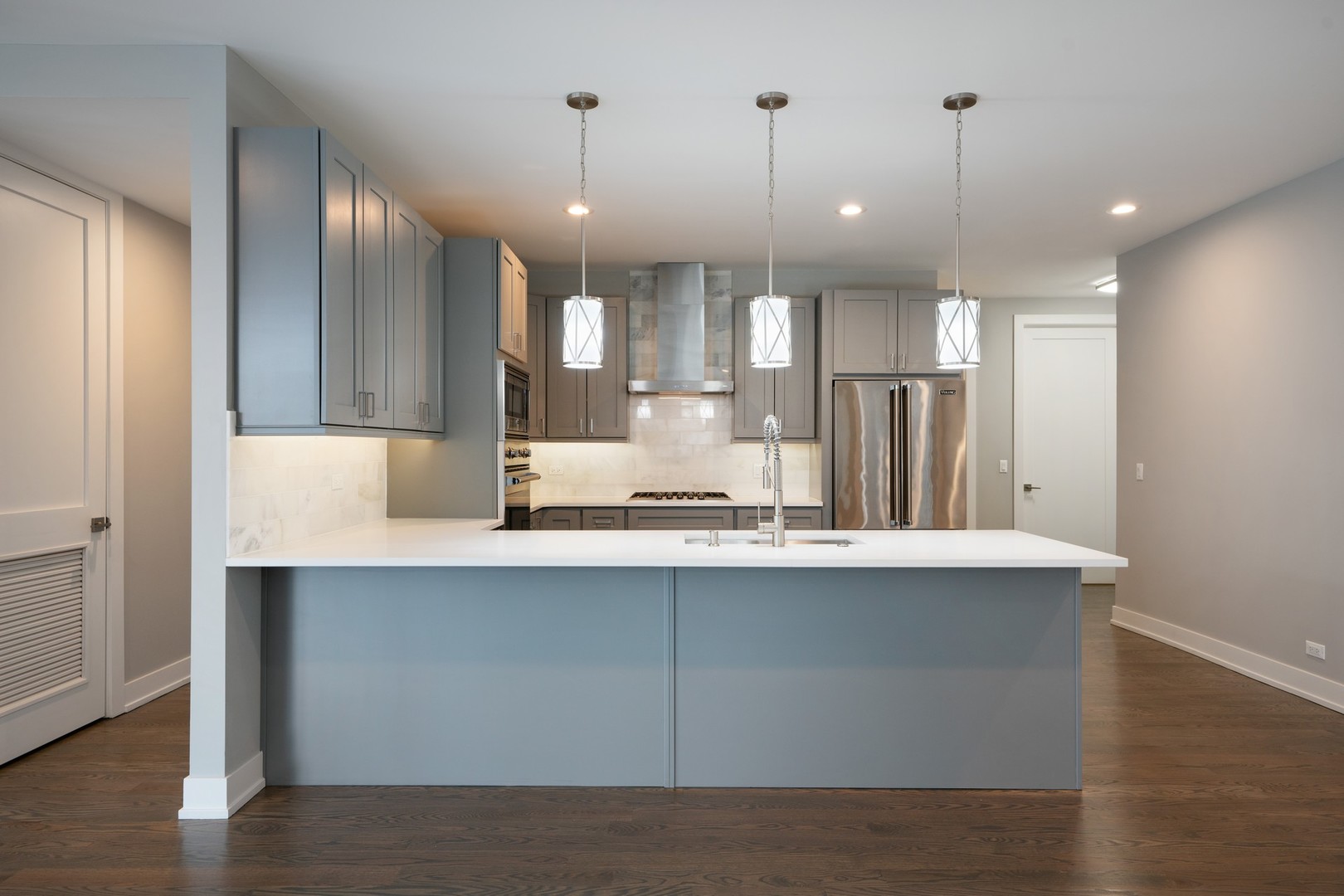 236 South Racine Avenue, Unit 304 Chicago, IL 60607 - Photo 7 of 23 a kitchen with kitchen island a sink stainless steel appliances and cabinets