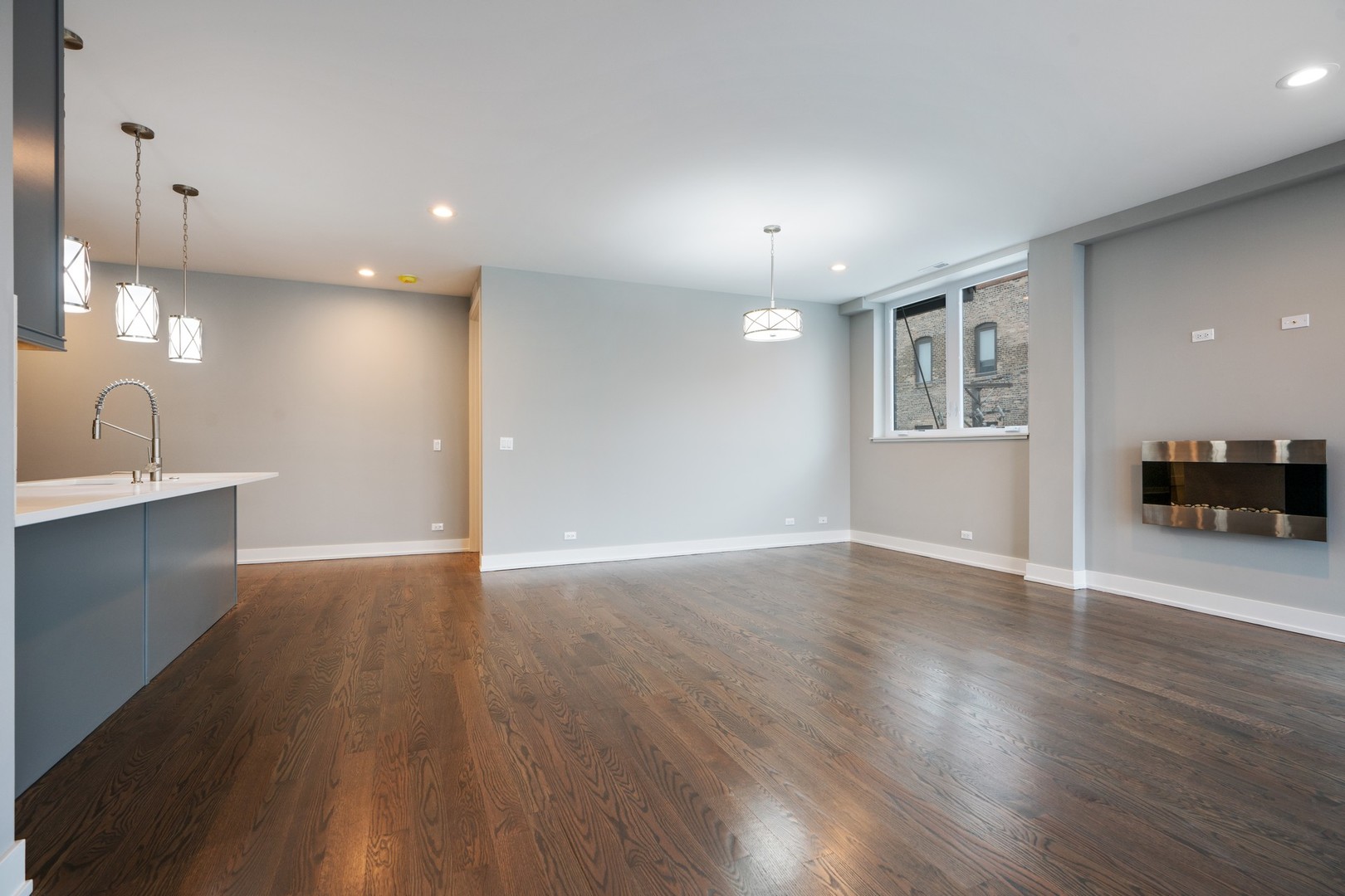 236 South Racine Avenue, Unit 304 Chicago, IL 60607 - Photo 8 of 23 a view of an empty room with wooden floor and a window