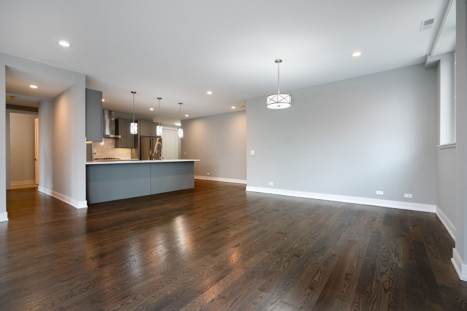 236 South Racine Avenue, Unit 304 Chicago, IL 60607 - Photo 9 of 23 an empty room with wooden floor and windows