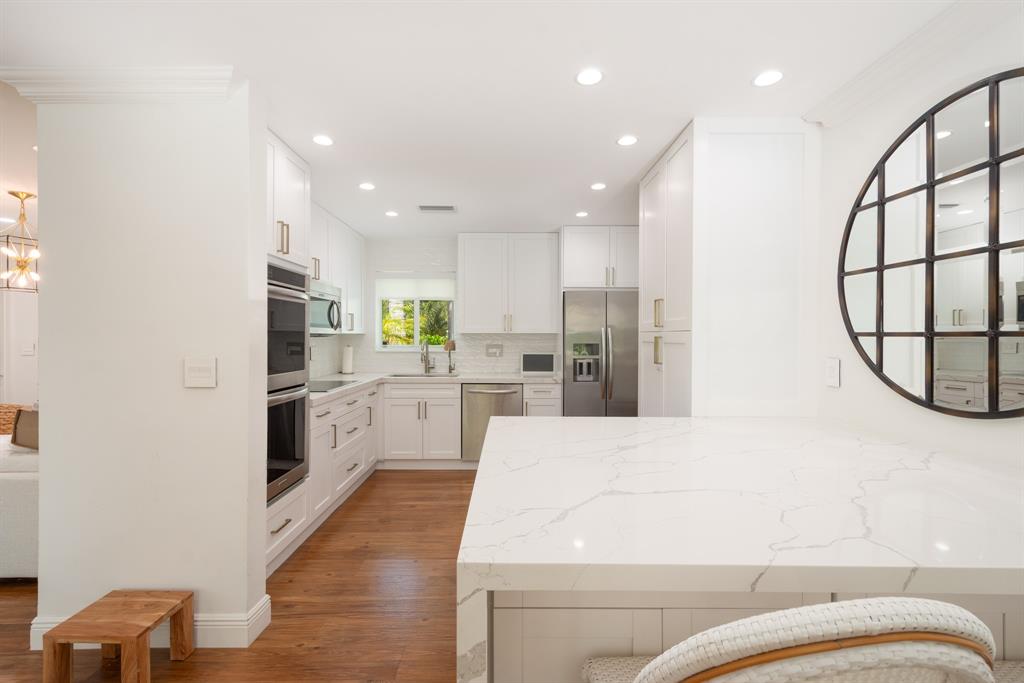 2800 Northeast 21st Avenue Lighthouse Point, FL 33064 - Photo 12 of 58 a kitchen with white cabinets and refrigerator