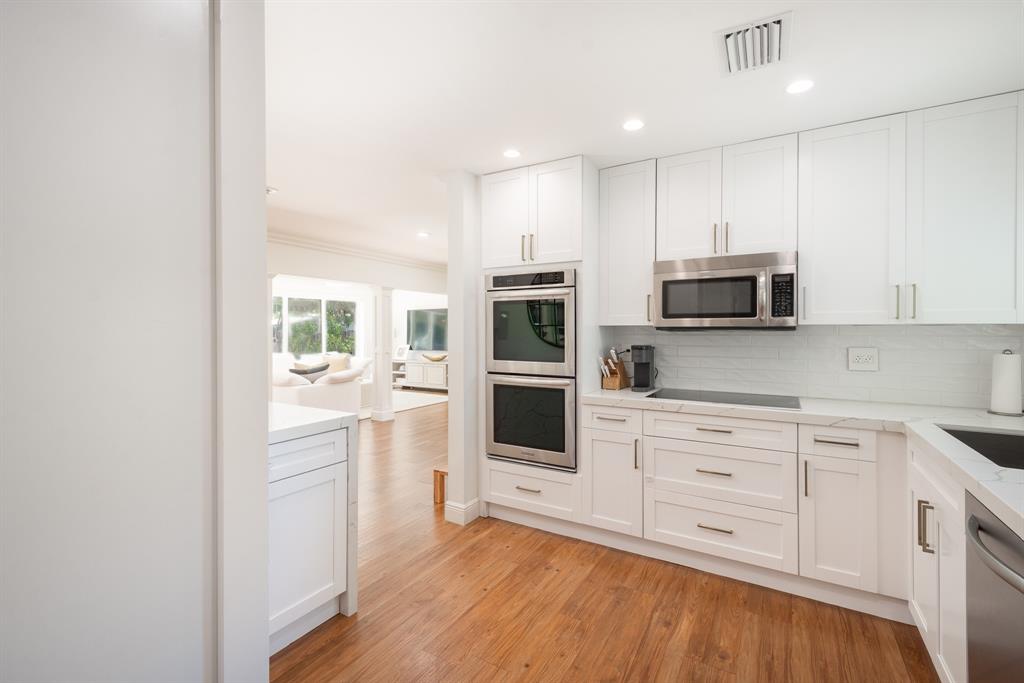 2800 Northeast 21st Avenue Lighthouse Point, FL 33064 - Photo 16 of 58 a kitchen with stainless steel appliances a refrigerator sink and microwave