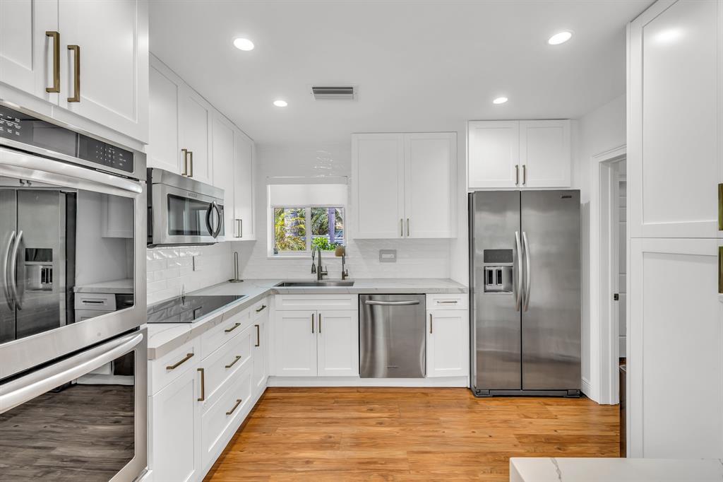2800 Northeast 21st Avenue Lighthouse Point, FL 33064 - Photo 17 of 58 a large kitchen with stainless steel appliances granite countertop a refrigerator and a sink