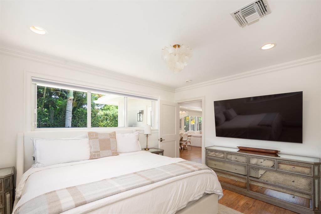 2800 Northeast 21st Avenue Lighthouse Point, FL 33064 - Photo 29 of 58 a bedroom with a bed a large window and a flat screen tv
