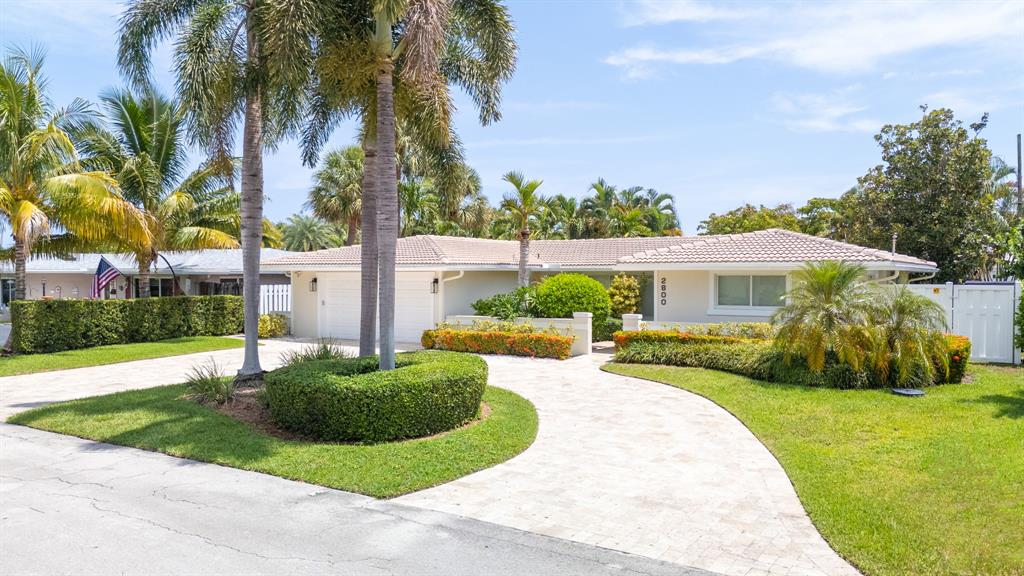 2800 Northeast 21st Avenue Lighthouse Point, FL 33064 - Photo 3 of 58 a front view of house with yard and green space