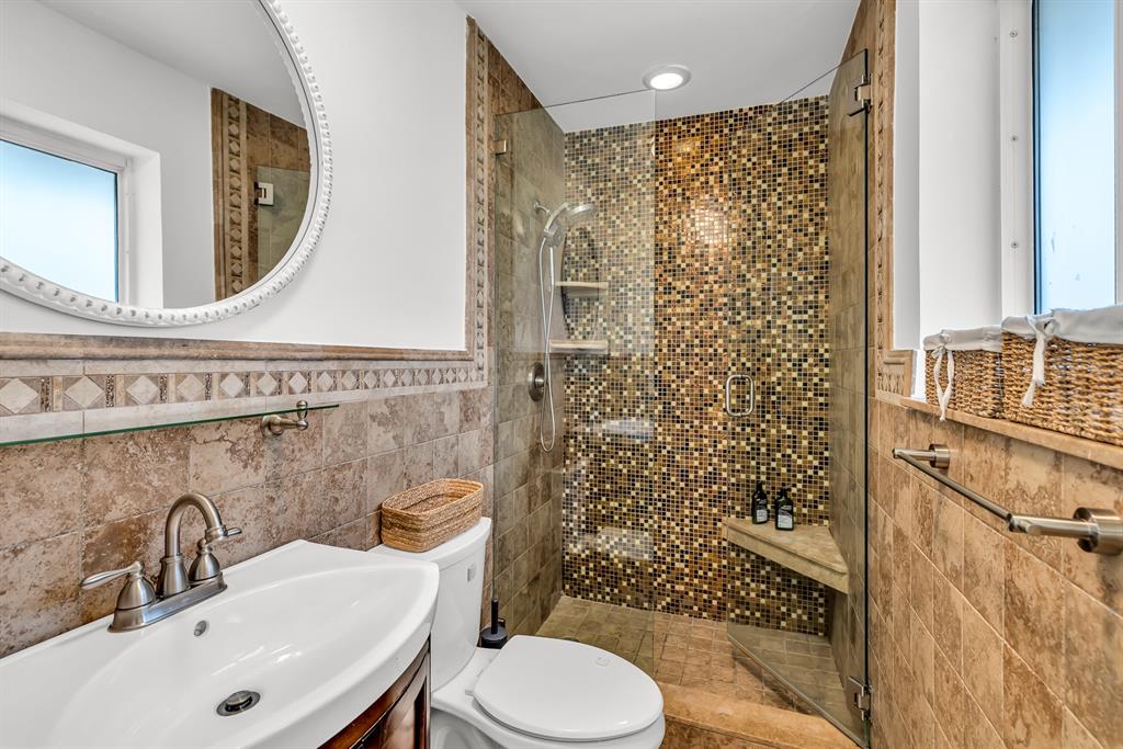 2800 Northeast 21st Avenue Lighthouse Point, FL 33064 - Photo 36 of 58 a bathroom with a sink toilet a mirror and shower