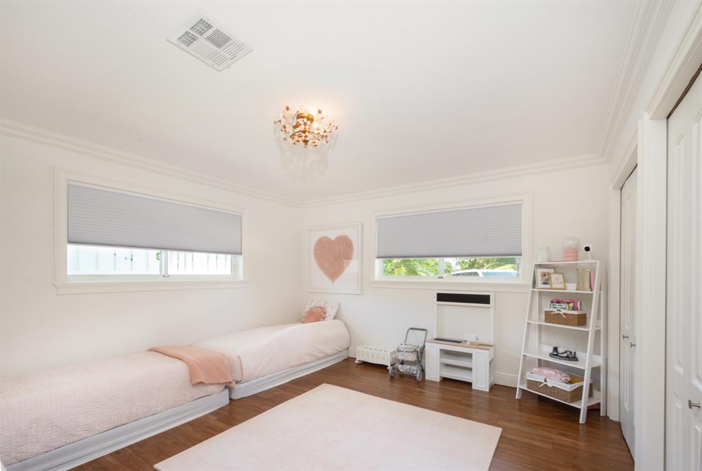 2800 Northeast 21st Avenue Lighthouse Point, FL 33064 - Photo 38 of 58 a bedroom with furniture and a wooden floor