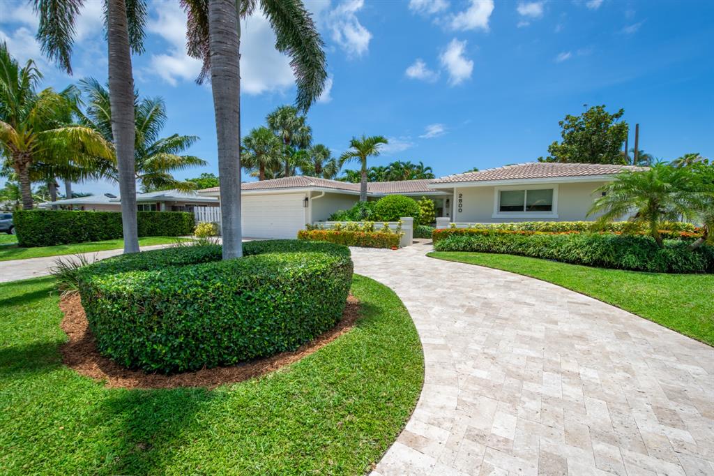 2800 Northeast 21st Avenue Lighthouse Point, FL 33064 - Photo 5 of 58 a view of a house with a yard and potted plants