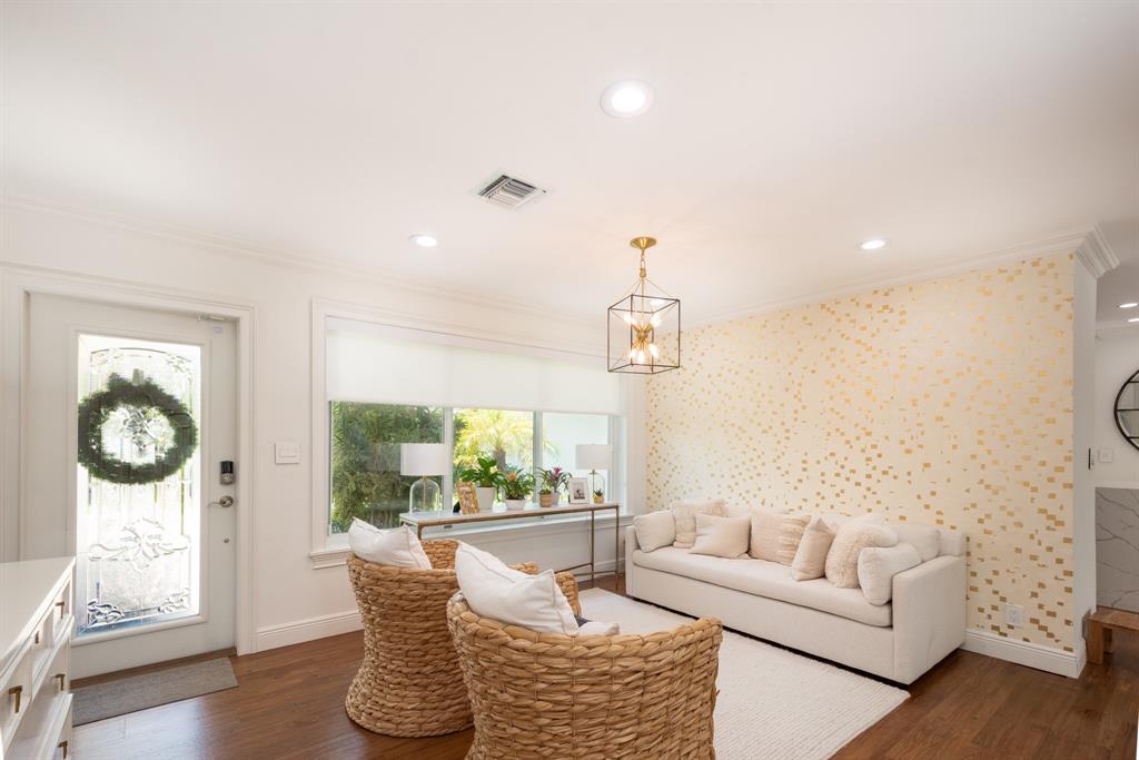 2800 Northeast 21st Avenue Lighthouse Point, FL 33064 - Photo 8 of 58 a living room with furniture a window and a chandelier