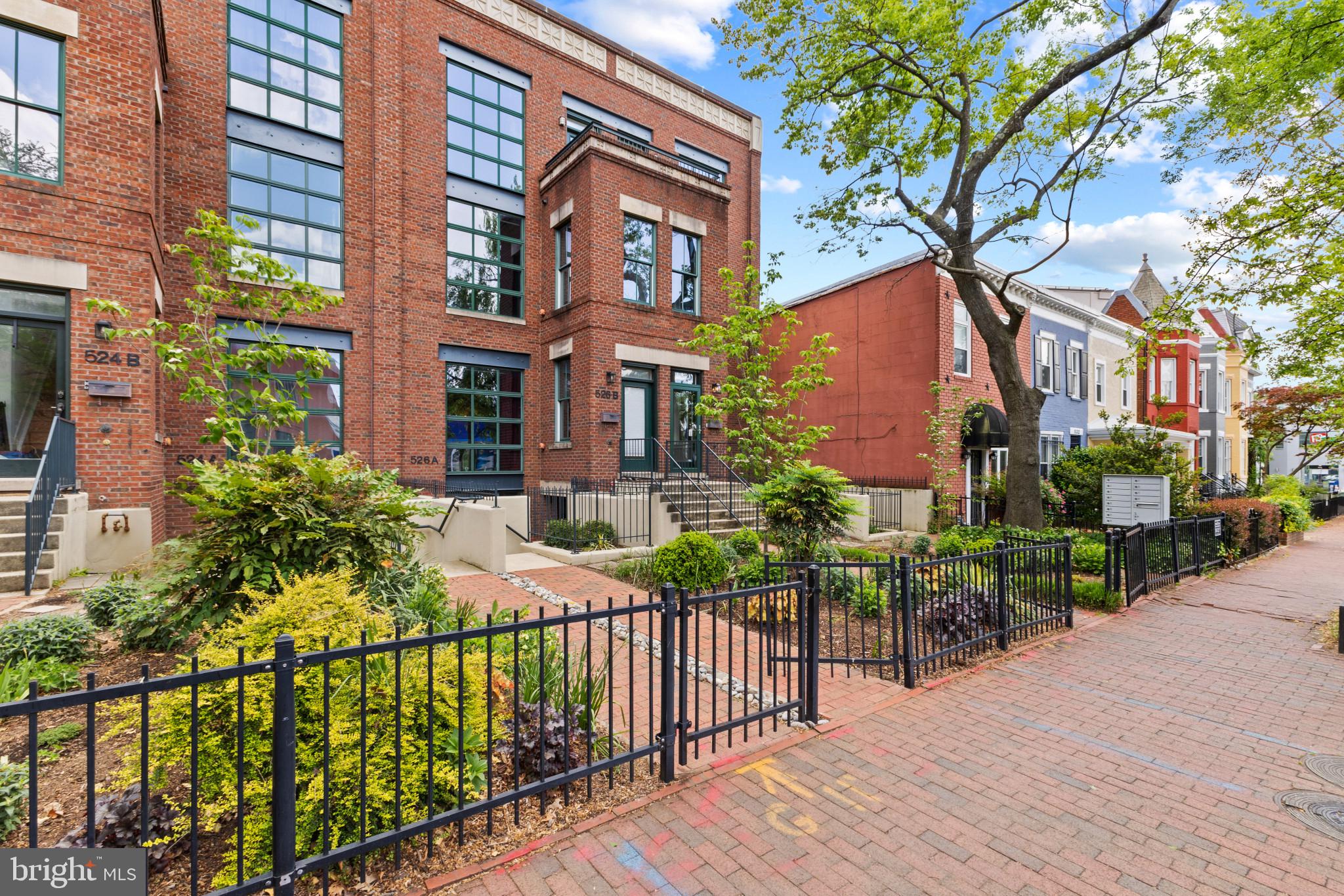 526 13th Street Southeast, Unit B Washington, DC 20003 - Photo 2 of 33 Charming brick facade with lush greenery.