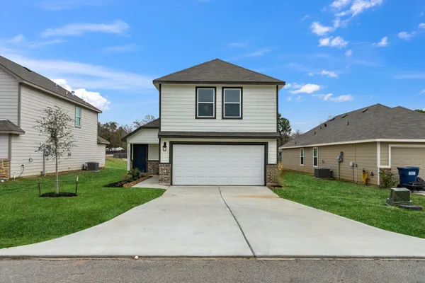 a front view of a house with a garden