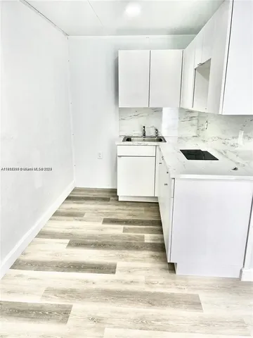 a kitchen with cabinets appliances and a counter space