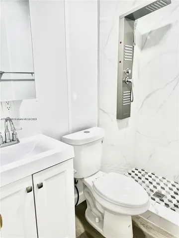 a bathroom with a sink a toilet and a mirror