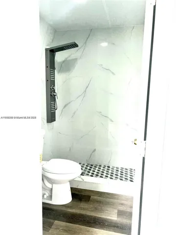 a bathroom with a toilet and a shower