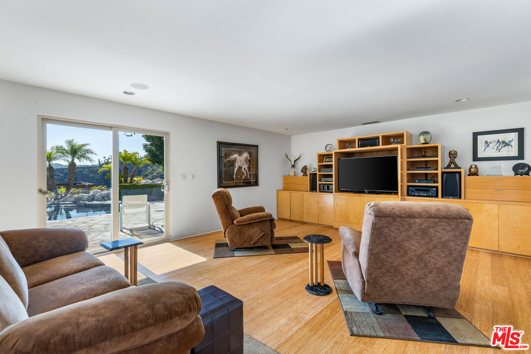 1641 Stradella Road Los Angeles, CA 90077 - Photo 12 of 23 a living room with furniture and a floor to ceiling window