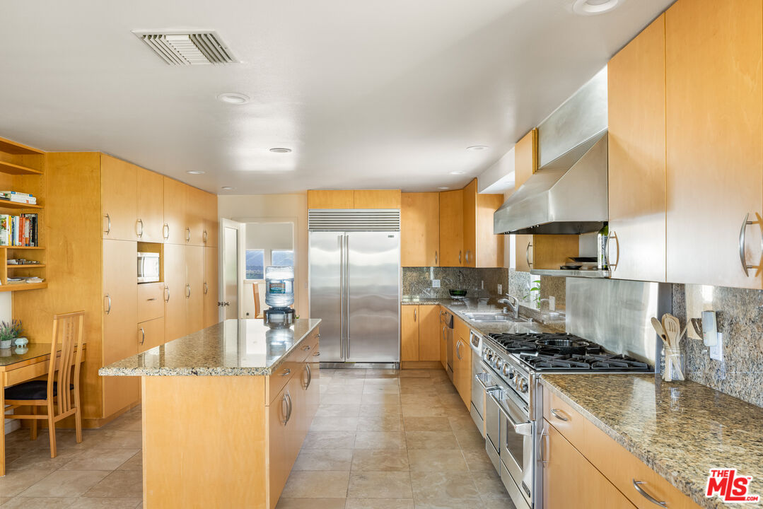 1641 Stradella Road Los Angeles, CA 90077 - Photo 16 of 23 a large kitchen with stainless steel appliances granite countertop a lot of counter space and a sink