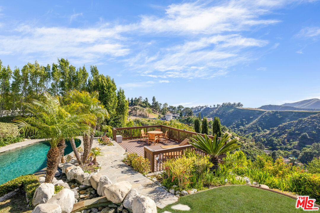1641 Stradella Road Los Angeles, CA 90077 - Photo 6 of 23 a view of a lake with a building in the background